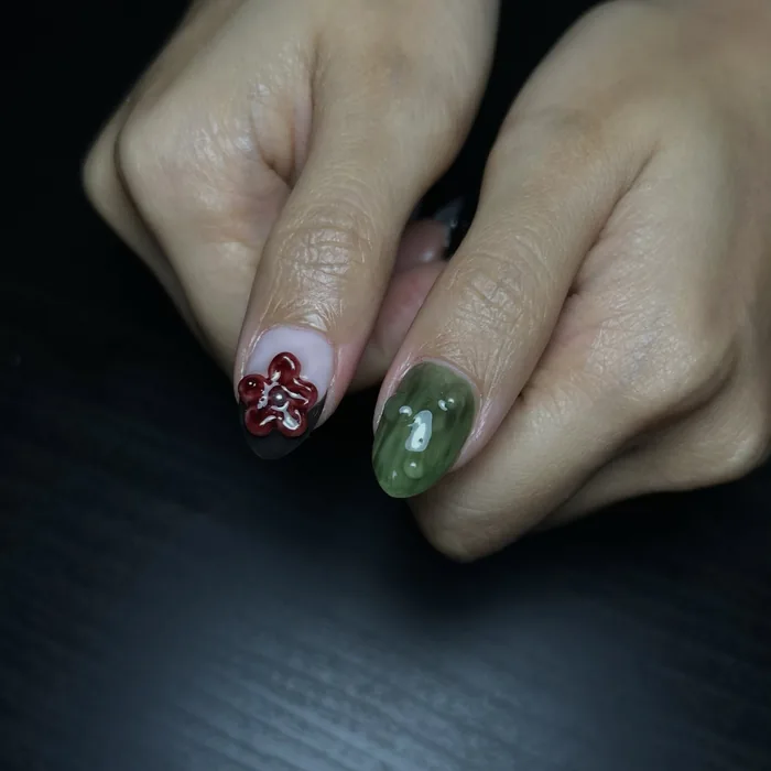 A close view of the Rafflesia nail, the red petals built up in relief