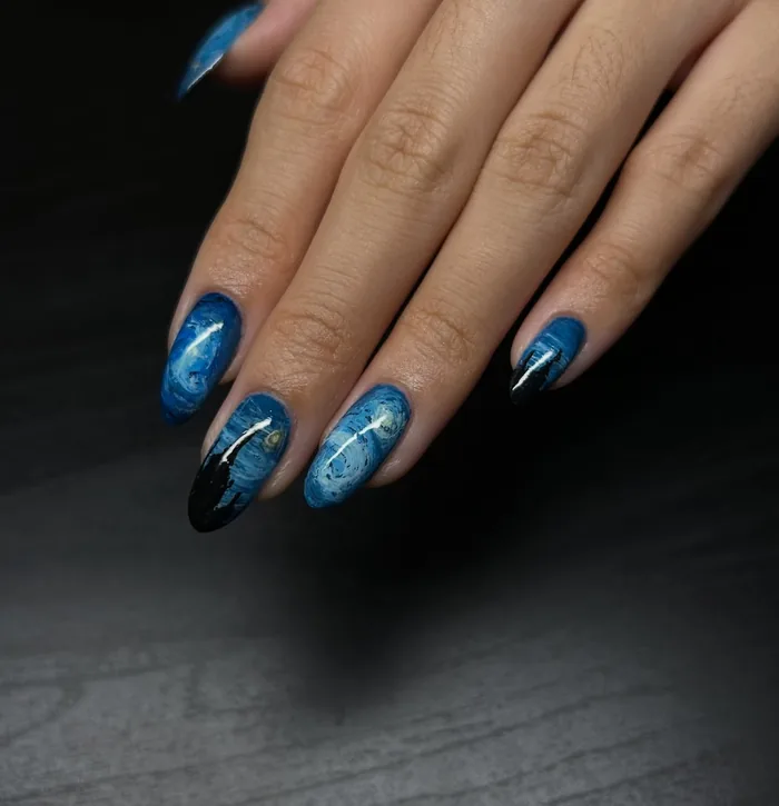 Starry Night painted across the nails in deep blue, with a black cypress tip